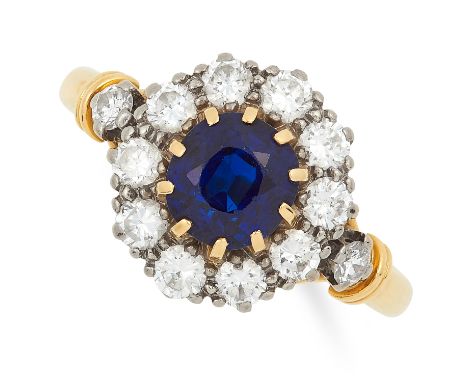 SAPPHIRE AND DIAMOND CLUSTER RING set with a round cut sapphire in a border of round cut diamonds, size N / 6.5, 4.6g.