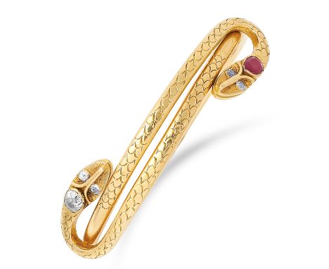 RUBY AND DIAMOND SNAKE BANGLE set with an oval cut ruby and old cut diamonds, 6cm inner diameter, 46.7g.