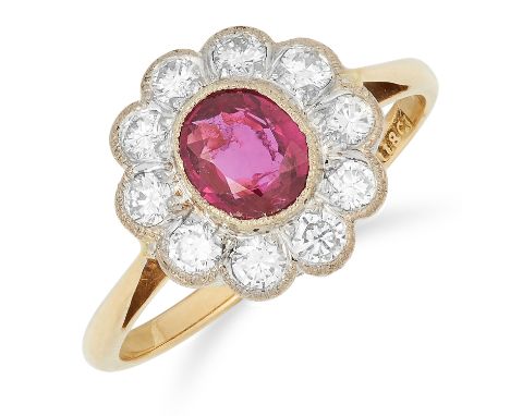 RUBY AND DIAMOND CLUSTER RING set with an oval cut ruby of approximately 0.68 carats, possibly Burma no heat, in a border of 