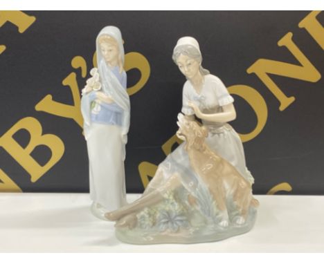 Lladro figure 4650 girl with Cala lilies together with A large Nao by Lladro figure of a woman petting a large dog