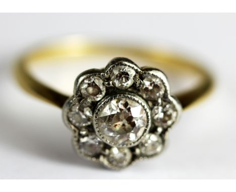 A yellow metal (tested 18ct gold) diamond set cluster ring, approx. 0.5ct, (E.5).