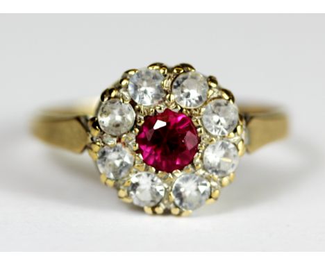 A 9ct yellow gold stone set cluster ring, (P).