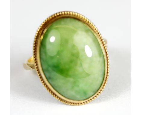 A 9ct yellow gold cabochon cut jade set ring, (Q).