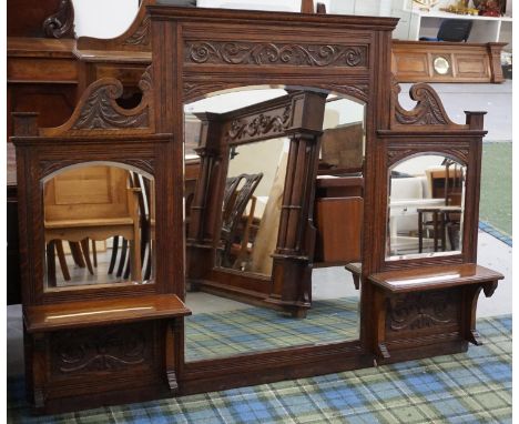 EDWARDIAN OAK OVERMANTLE MIRROR BACKpossibly an upper section to a sideboard, with a carved pediment with a scroll panel abov