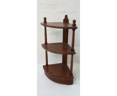 ERCOL OAK OPEN CORNER SHELF UNITwith three shaped shelves raised on a plinth base, 80.5cm high 