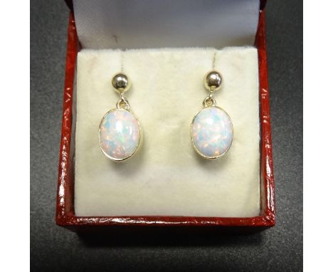 PAIR OF OPAL DROP EARRINGSthe oval cabochon opals in nine carat gold settings 