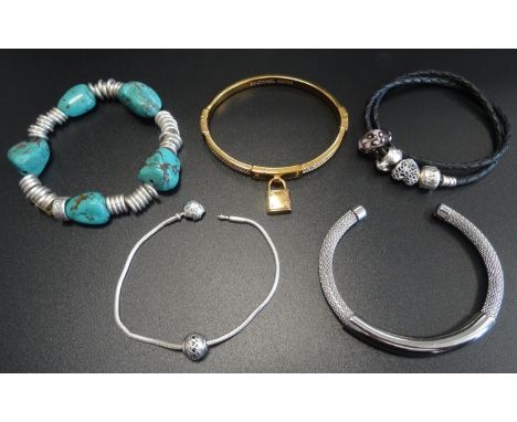 SELECTION OF FASHION JEWELLERY comprising a Pandora double braided charm bracelet with three charms; a Michael Kors pave set 