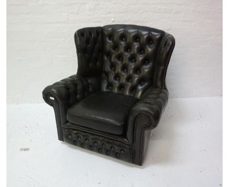 GREEN LEATHER CHESTERFIELD WING BACK ARMCHAIR with a button back and arms, on castors 