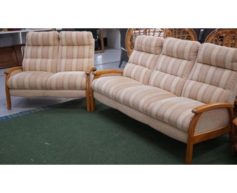 HONEY OAK FRAME THREE SEAT SOFAwith shaped back cushions, standing on shaped supports, 180cm wide and a similar two seat sofa