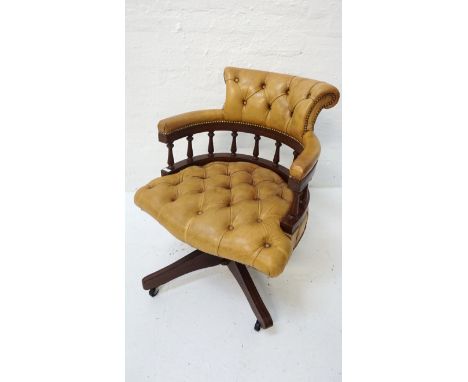 MUSTARD YELLOW LEATHER CAPTAINS CHAIRwith a button back and seat, on a swivel base with four shaped supports with castors 