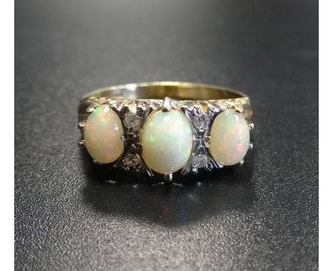 OPAL AND DIAMOND RINGthe three oval cabochon opals separated by small diamonds, on nine carat gold shank, ring size R-S 