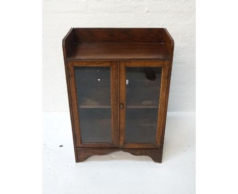 OAK GLAZED BOOKCASEearly 20th century, with gallery top above two glazed doors with shelf interior, 89cm high x 60.5cm wide 