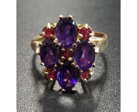 UNUSUAL AMETHYST AND RUBY CLUSTER RINGthe four oval cut amethysts interspersed with small rubies, on nine carat gold shank, r