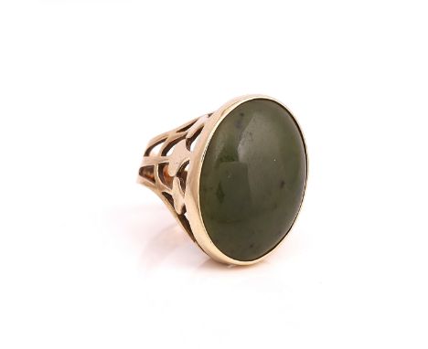 A 9CT GOLD AND NEPHRITE RINGCollet set with a large oval nephrite between pierced shoulders, London 1976. Ring size M, gross 