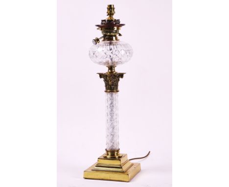 A LATE VICTORIAN BRASS AND GLASS CORINTHIAN COLUMN TABLE LAMPCirca 1897Later adapted for electricity, with glass reservoir an