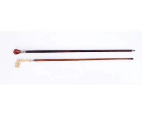 AN ART NOUVEAU SILVER MOUNTED AMBER WALKING CANE AND ANOTHER (2)Early 20th CenturyThe first with pommel handle and rosewood s