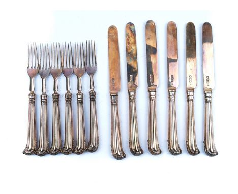 A SET OF SIX SILVER PAIRS OF FRUIT KNIVES AND FORKS (12)With loaded pistol grip style handles, silver blades and silver prong