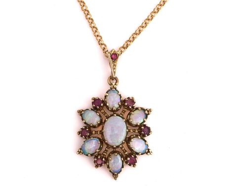 A GOLD, OPAL AND MAUVE GEM SET PENDANT WITH A 9CT GOLD NECKCHAIN (2)The pendant mounted with the principle oval opal in a sur