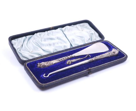 A VICTORIAN SILVER MOUNTED THREE PIECE BUTTON HOOK AND SHOE HORN SETComprising; a steel shoe horn, a steel ended larger butto