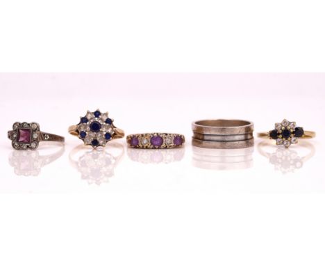 A 9CT GOLD, AMETHYST AND DIAMOND FIVE STONE RING AND FOUR FURTHER RINGS (5)Mounted with three circular cut amethysts and with