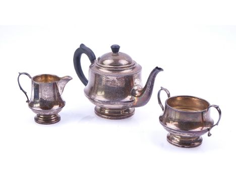 A SILVER THREE PIECE TEA SET (3)Comprising; a teapot having black composition fittings, a twin handled sugar bowl and a milk 