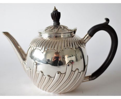 A VICTORIAN SILVER TEAPOTOf spherical form with spiral fluted decoration and with black fittings, London 1895, gross weight 4