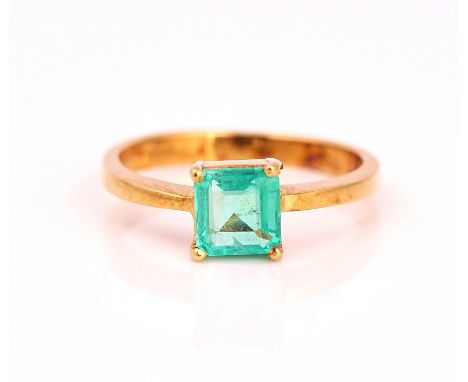 A GOLD RING CLAW SET WITH A CUT CORNERED RECTANGULAR STEP CUT EMERALDDetailed 18K, ring size N, gross weight 3.2 gms.Conditio