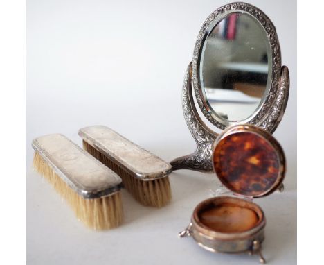 A SILVER MOUNTED MIRROR AND THREE FURTHER ITEMS (4)The strut backed mirror frame fitted with a swinging oval bevel glassed mi