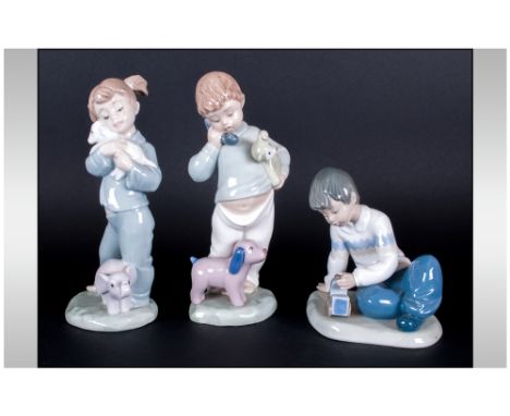 Three Nao by Lladro Porcelain Figures comprising two boys and a girl with soft toys and train, Various sizes.