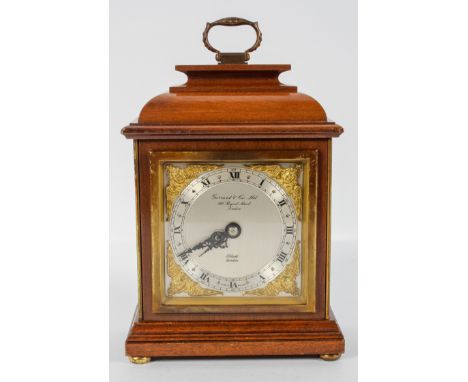 An Elliot of London mahogany cased mantel clock, with mechanical movement, in caddy top case, the dial marked "Garrard &amp; 