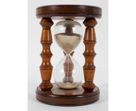A turned wood sand timer, probably 20th century, with three turned supports, 15.5cm high