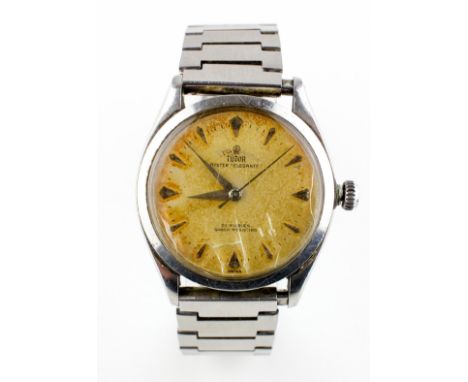 A stainless steel Tudor Oyster Elegante wristwatch. Circular 34.0mm dial; champagne with baton markings. Manual wind movement
