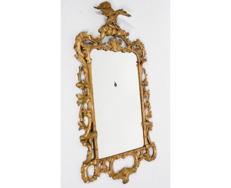 A Chippendale style gilt wall mirror, the rectangular plate in a scrolling pierced frame, surmounted by a ho-ho bird, 117cm h