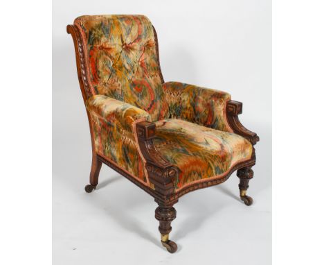 A Victorian oak framed armchair, with button back, serpentine seat and carved front legs, 95cm high