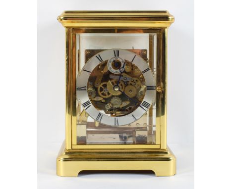 A Kieninger brass mantel clock, the brushed steel chapter ring with subsidiary seconds dial, visible three train movement wit