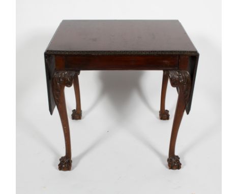 A Chippendale style mahogany drop leaf table, the moulded top on scrolling legs with foliate decoration and  claw on ball fee