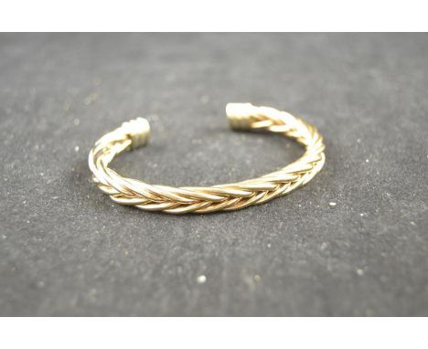 A 9ct gold torque bangle of plaited form - approx weight 45.8g CONDITION REPORT: good condition
