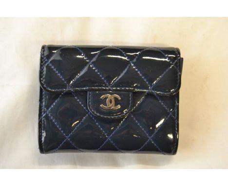 A Chanel quilted patent leather coin purse in navy blue, flap fastening with popper, patch pocket to rear, interior with thre