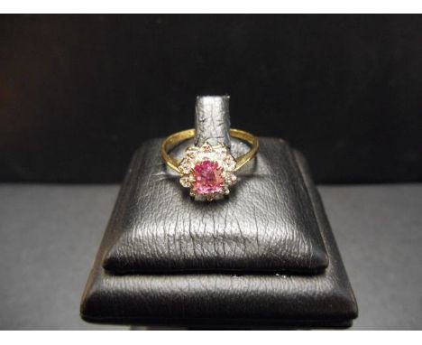 An 18ct gold ring with a pink sapphire surrounded by diamonds in a floral setting, size M - approx gross weight 2.4g CONDITIO