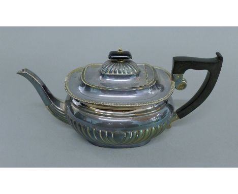 A silver teapot. 29 cm long. 23.2 troy ounces total weight.