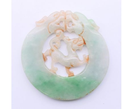 A jade roundel.  5.5 cm diameter. 
