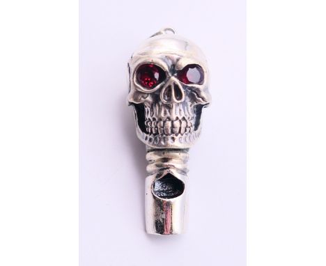 A silver whistle pendant in the form of a skull.  4 cm high. 