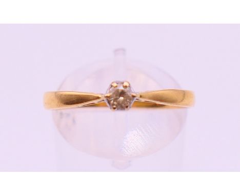 An 18 ct gold diamond solitaire ring. Ring size R/S.