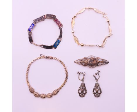 A collection of silver jewellery, to include three bracelets, a pair of earrings and a brooch.  Brooch 5.5 cm wide. 
