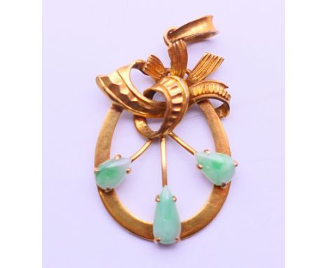 A jade set 14 K gold pendant.  3 cm high. 2.8 grammes total weight.  