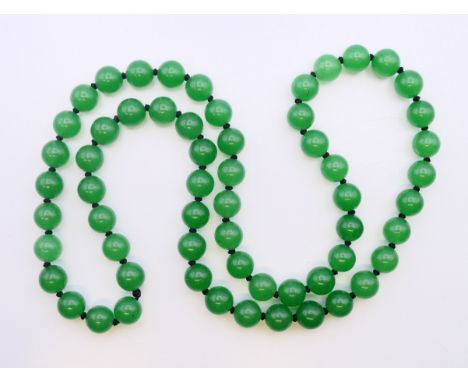 A string of jade beads. Approximately 66 cm long.