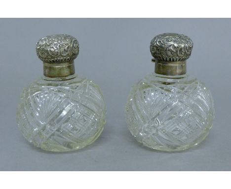 A pair silver-topped cut glass scent bottles. 11 cm high. 