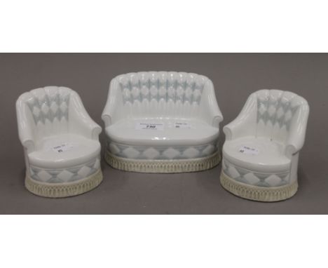A Lladro porcelain three-piece suite. The largest 16 cm wide.