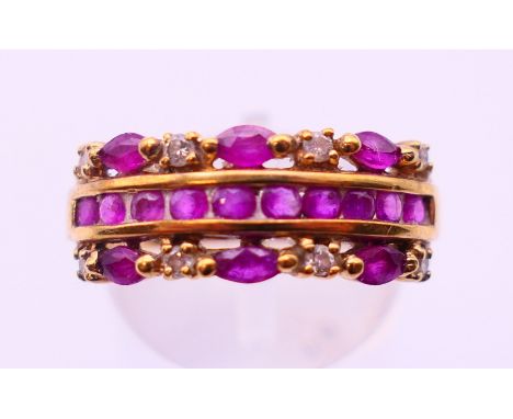 A 9 ct gold three-row diamond and ruby ring. Ring size P. 