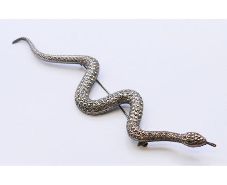 A polished stone set silver snake form brooch.  18 cm long.